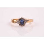 A sapphire and diamond cluster ring, the oval cut pale sapphire in claw mounts within a border of