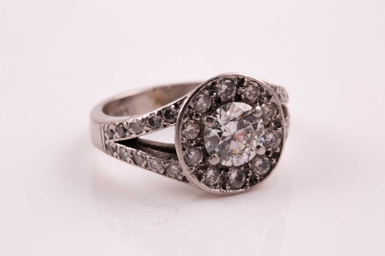 A diamond cluster ring, the central brilliant cut diamond in four claw mount above a channel set - Image 5 of 5