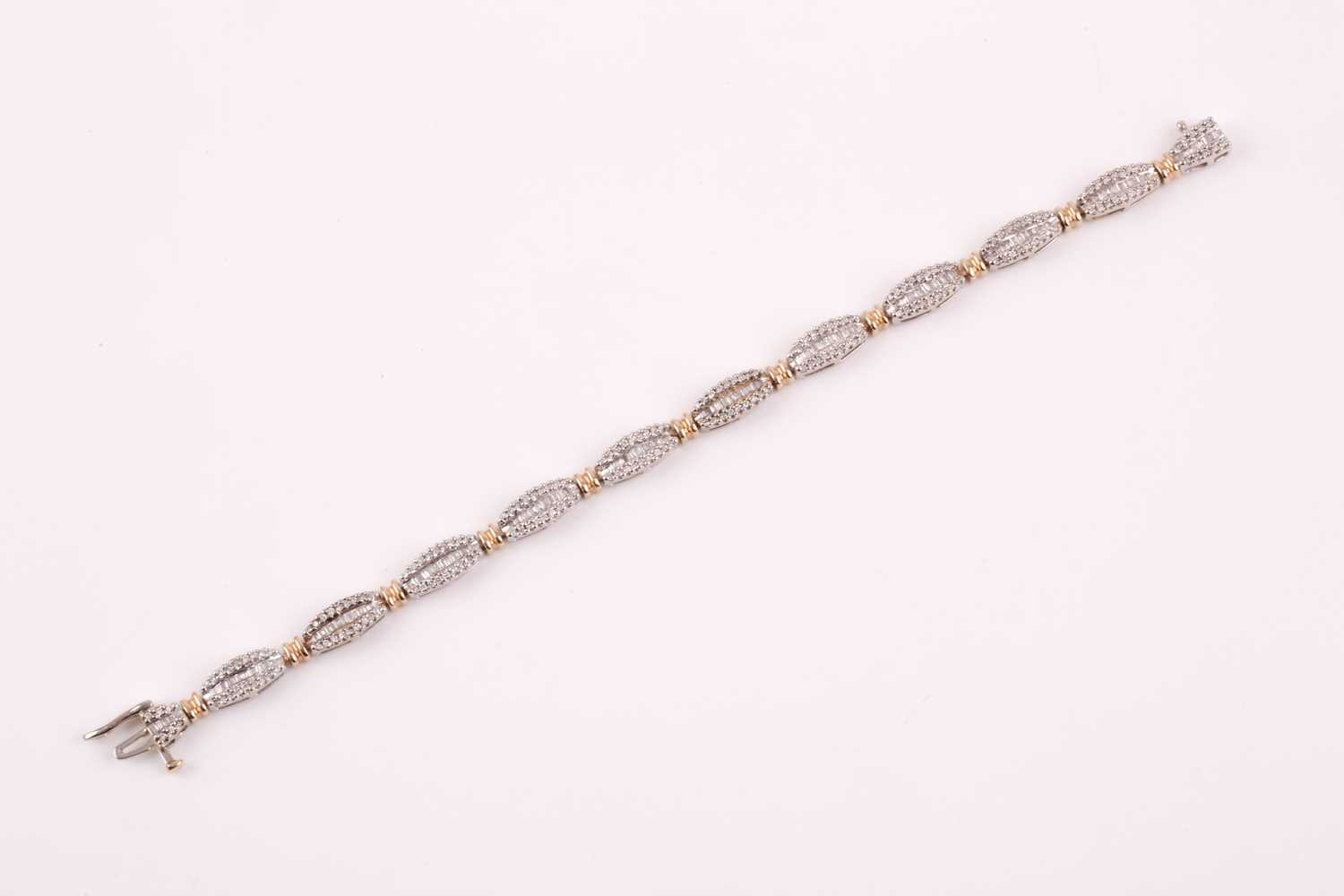 A diamond line bracelet, the tapered segments inset with mixed baguette-cut and round-cut