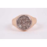 A gents yellow metal signet style ring, inset with seven round white stones, size Q.Condition