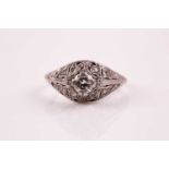 An Art Deco diamond ring; the old brilliant cut diamond in raised claw mount above domed foliate