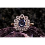 A diamond and sapphire ring, collet-set with a mixed oval-cut sapphire of approximately 1.0