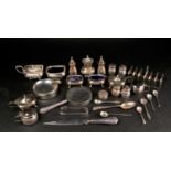 Assorted silver to include, five condiment sets, a six division toast rack, an ashtray, a silver