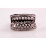 An unusual 18ct white gold and diamond ring, set with three rows of stem-set round-cut diamonds,