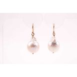 A pair of yellow metal and baroque pearl drop earrings, each set with a naturalistic pearl, 3 cm