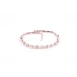 A platinum and diamond bracelet, set with eleven graduated old round-cut diamonds, of