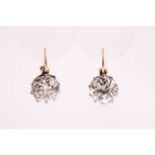 A pair of Old European cut solitaire diamond earrings, the diamond in excess of 6.0 carats combined,