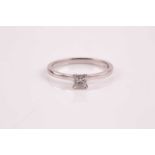 A single stone diamond ring, the princess cut diamond in simple four claw mount to a plain