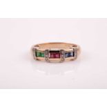 A 9ct yellow gold, sapphire, ruby, and emerald ring, the band set with square calibre-set stones