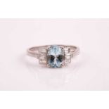 A platinum, diamond, and aquamarine ring, in the Art Deco style, set with a mixed oval-cut