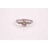 A single stone diamond ring; the old cushion cut diamond in eight claw mount, the shoulders each set