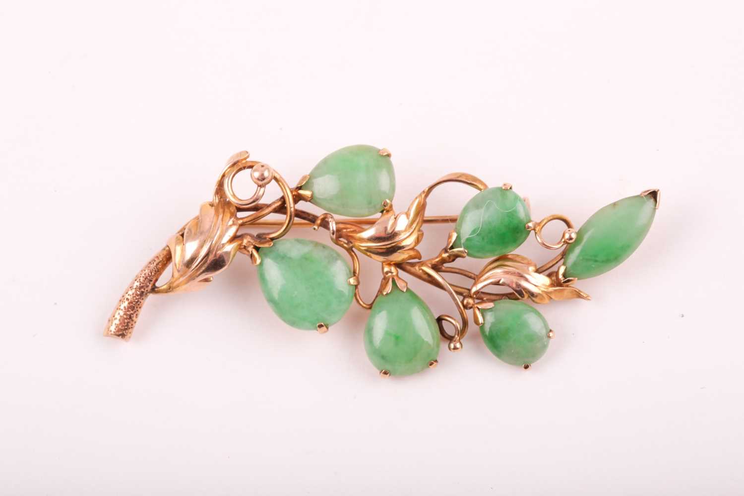 A 14ct yellow gold and jadeite brooch, of foliate design, stamped 14K.Condition report: 6.8g