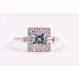 A platinum, diamond, and aquamarine ring, in the Art Deco style, set with a mixed square-cut aqua,
