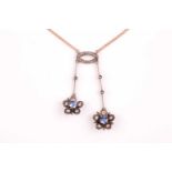 A diamond and sapphire drop pendant lavelier necklace, the two floral clusters centred with round-