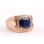 An impressive diamond and sapphire ring, set with a mixed cushion-cut sapphire of approximately 11.