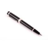 Cartier. A black and silver rollerball pen, with twist mechanism, bearing logo to top of pen lid.