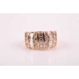 A 14ct yellow gold and diamond ring, bar-set with rows of round brilliant-cut and mixed baguette-cut