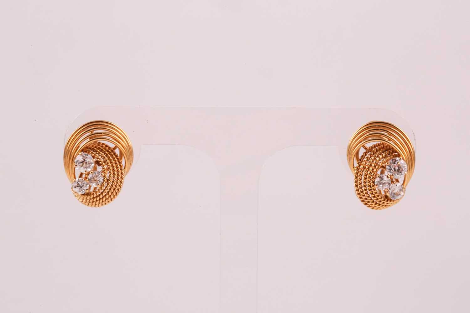 A pair of 18ct yellow gold and diamond earrings, each with a swirled rope-twist mount set with three