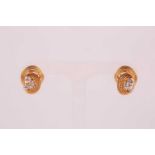 A pair of 18ct yellow gold and diamond earrings, each with a swirled rope-twist mount set with three