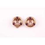 A pair of Arts and Crafts 9ct yellow gold and garnet earrings, the round frame mounts each set