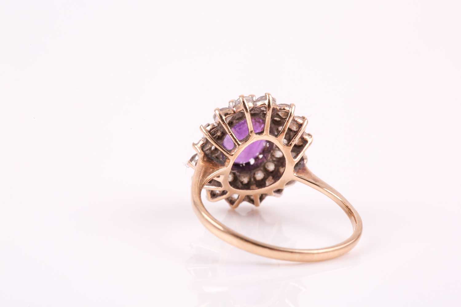 A 9ct yellow gold, amethyst, and white paste stone cluster ring, set with a mixed oval-cut - Image 3 of 6