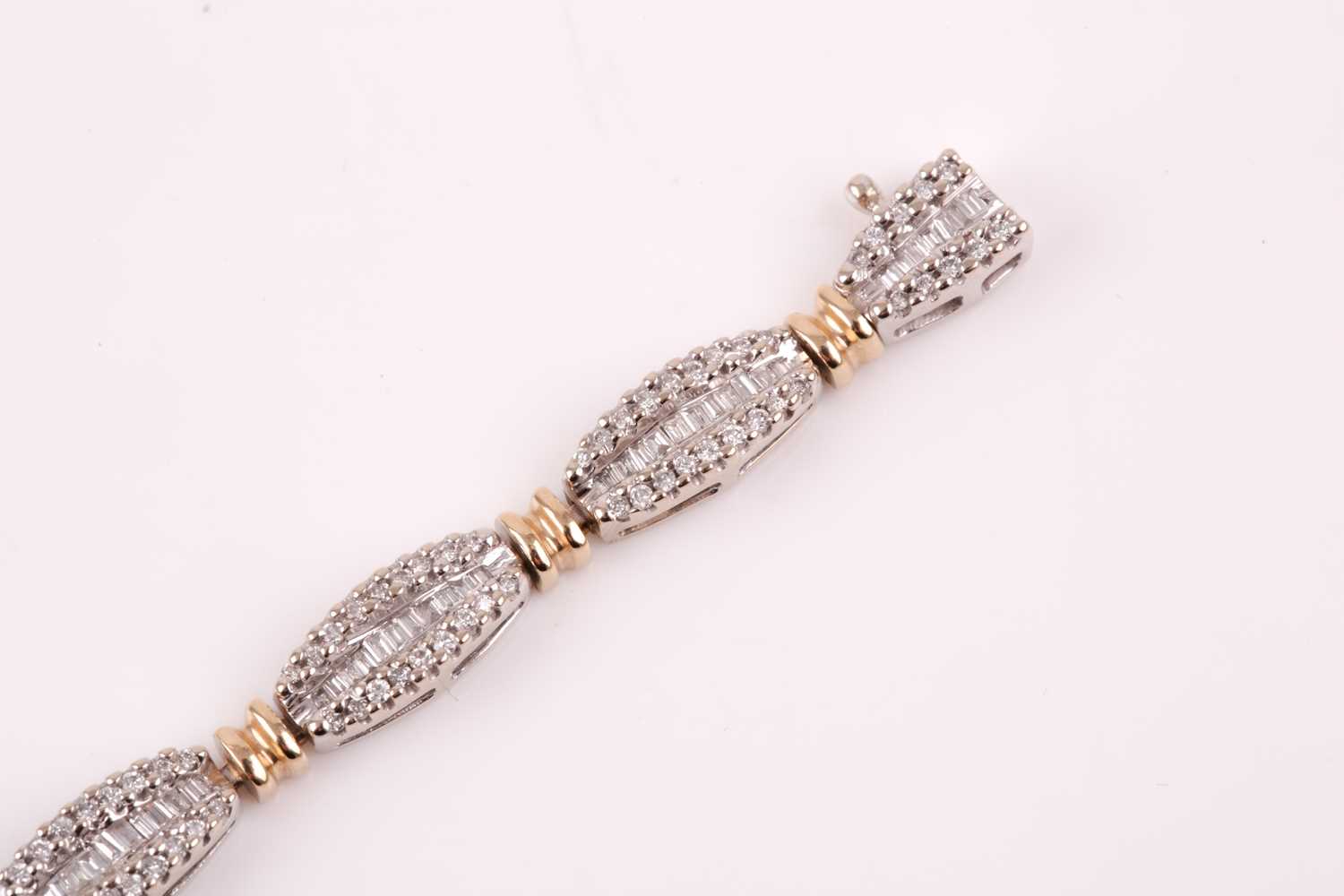 A diamond line bracelet, the tapered segments inset with mixed baguette-cut and round-cut - Image 3 of 7