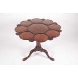 A George III mahogany, Irish, petal-edged birdcage supper table, with "Dublin Shell' carved detail