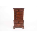 A George III style mahogany, miniature chest on chest, the upper section with two short over three