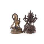 A Sino Tibetan patinated bronze figure of green Tara seated on a double lotus socle with hands in