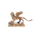 A cast brass grand tour style brass scroll weight in the form of the 'Lion of Saint Mark', with