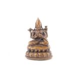 A Tibetan bronze figure of Tsongkhapa, late 17th/18th century, seated in the lotus position upon a