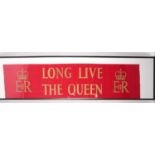 A large red and gold crepe paper banner from the Coronation of Her Majesty Queen Elizabeth II (
