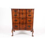 A Queen Anne styler walnut veneered chest of drawers, 20th century, the inverted breakfront with