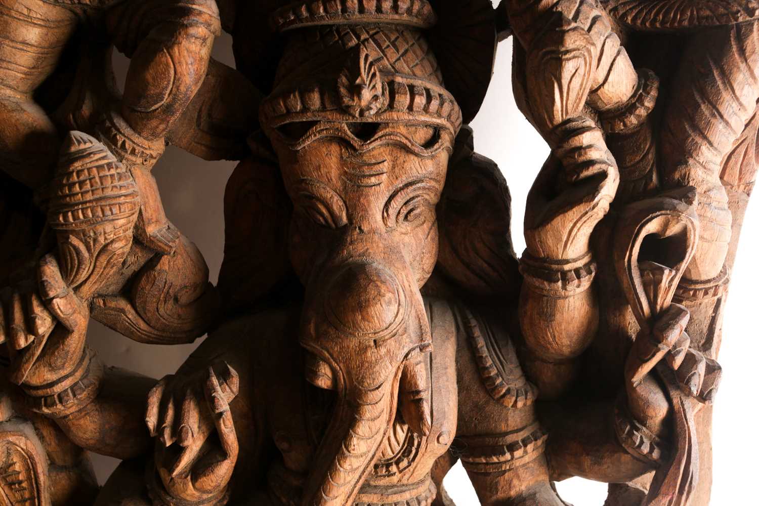 An Indian teak wood arched architectural panel, carved and pierced with Lord Ganesh and attendants - Image 2 of 8