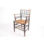 A 19th-century arts and crafts "Sussex" open armchair with traditional spindle back and woven