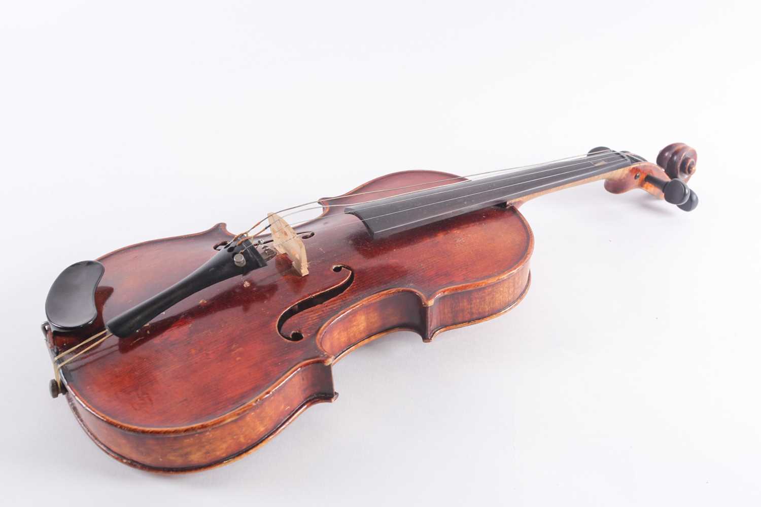 A German three-quarter violin with scarfed scroll and two-piece figured back. Bearing a "Caspar Da