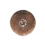 A Chinese carved russet/kahki jade Bi disc carved with tigers, dragons, and phoenix on a cloud-