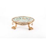 A Chinese celadon glazed dish, painted with polychrome enamels depicting butterflies, moths and