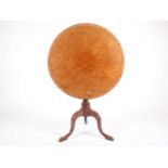 A George III mellow straw mahogany tilt top tripod table, circa 1780/90, the circular top with