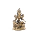 A Sino Tibetan gilt-bronze figure of green Tara seated on double lotus socle in the green Tara mudra