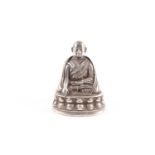 A Tibetan or Nepalese white metal seated figure of Taklung Lama or Pagmodrupa, probably 19th/20th