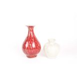A Chinese white glazed segmented globular vase, Song dynasty, painted with underglaze red decoration