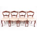A set of four Victorian mahogany dining chairs, with stuff over buttoned seats, on french cabriole