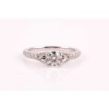 An 18ct white gold and diamond ring, set with a round brilliant-cut diamond of approximately 0.60