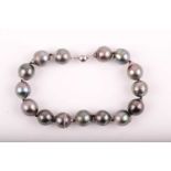 A South Sea black pearl bracelet, the rounded pearls approximately 12mm diameter, fastened with an