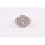 A platinum and diamond ring, the graduated mount set with five rows of round-cut diamonds, total