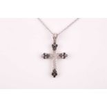 An 18ct white gold and diamond cross pendant, set with black and white round-cut diamonds, pendant