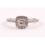 An 18ct white gold and diamond cluster ring, set with a princess-cut diamond of approximately 0.47