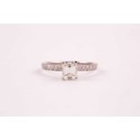 An 18ct white gold and diamond ring, set with an emerald-cut diamond of approximately 0.91 carats,