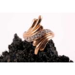 A mid to late 20th entury yellow gold and diamond ring, of retro design, the swept crossover mount